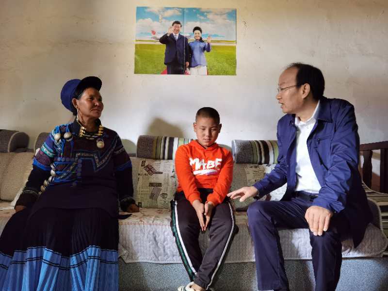 图片：周长奎（右一）在视力一级残疾人吉力俄日家入户调研